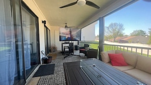 Patio with comfortable seating, fire table and TV that can be rolled out.