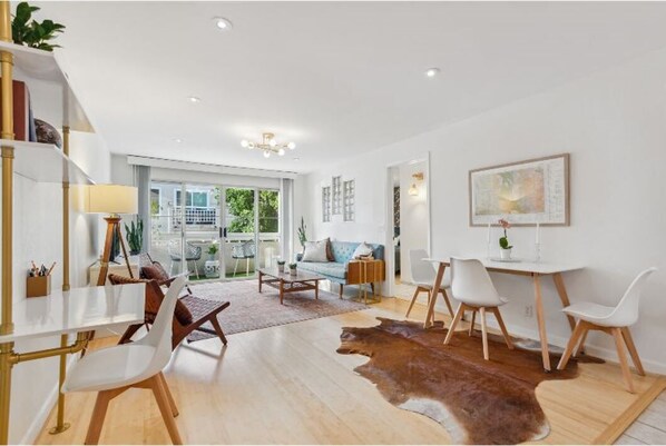 The bright, spacious living room, with dining area and work space.