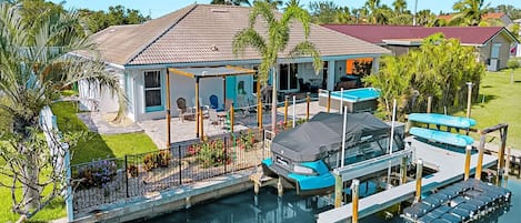 Enjoy a stunning exterior view of the home with direct access to the peaceful canal river, perfect for waterfront relaxation.