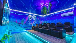 Immersive underwater-themed theater with recliners, LED glow, and epic vibes.