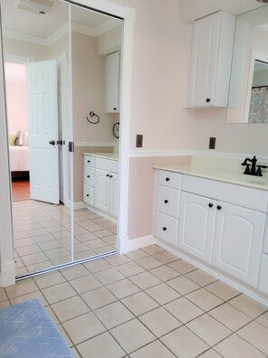 Master bath with full length mirror and walk-in closet