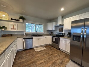 Open kitchen with updated modern appliances