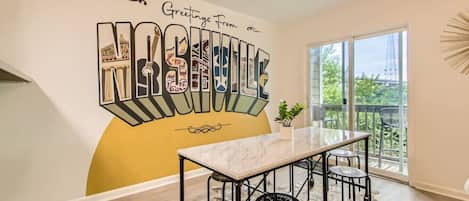 Dining table with seating for 6. The dining area opens up into the living room. Private patio off of this room. Take a photo in front of our custom Nashville mural.