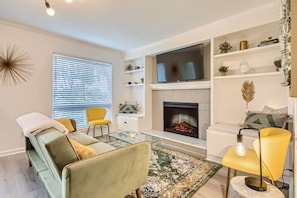 Comfortable living room, that is connected to the dining area. The couch turns into a sleeper sofa. Smart TV with all the apps you could want. Electric fireplace for use as well!