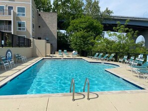 Seasonal community pool with outdoor patio furniture. Overlooking the Cumberland River.