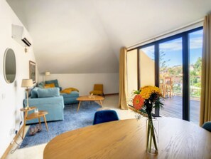 The interior of this apartment boasts tasteful décor that seamlessly blends relaxation with modern aesthetics, creating a cozy and inviting atmosphere. #flowers #terrace #diningtable #livingroom