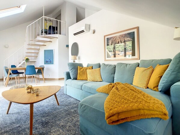 A top-floor apartment adorned with soothing décor, where relaxation takes center stage with this welcoming yellow & blue