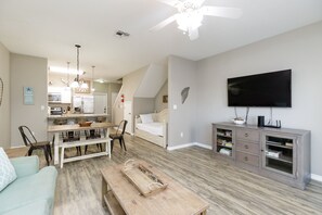 Open concept living, dining and kitchen space with bright natural lighting