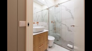 Modern bathroom wish a shower, toilet, sink and mirror. TP, towels and hairdryer are included for your convenience! #bathroom #airbnb