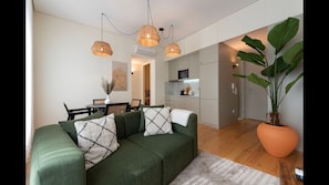 Main area with a fully equipped kitchenette, dining area for 4, a comfortable sofa and a flat screen TV. #dining #kitchen #livingroom #lovelystay