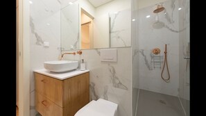 Modern bathroom wish a shower, toilet, sink and mirror. TP, towels and hairdryer are included for your convenience! #bathroom #airbnb