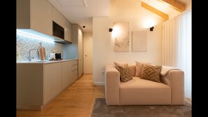 Main area with a fully equipped kitchenette, dining area for 2, a comfortable sofa and a flat screen TV. #dining #kitchen #livingroom #lovelystay