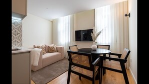 Main area with a fully equipped kitchenette, dining area for 4, a comfortable sofa and a flat screen TV. #dining #kitchen #livingroom #lovelystay