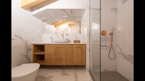 Modern bathroom wish a shower, toilet, sink and mirror. TP, towels and hairdryer are included for your convenience! #bathroom #airbnb