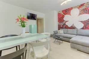 Living room has a 42" smart LED TV with satellite channels