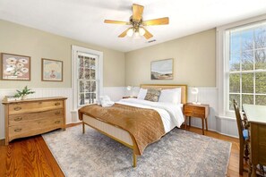 Our Primary bedroom features a Queen-size bed, closet, dresser, desk and nearby bath.