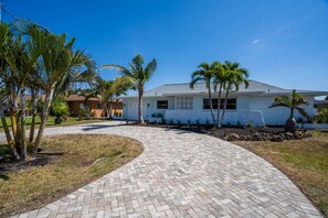 Beautiful landscaped home with palm trees and privacy.