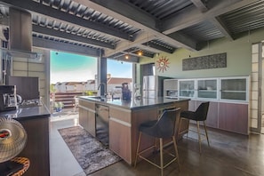 Large, modern kitchen with Massive island. Opens onto balcony