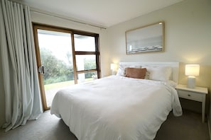 Beautiful queen bed with side lamps, adjustable lights and a Dyson fan/heater