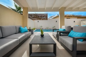 lounging area in private backyard with views of pool