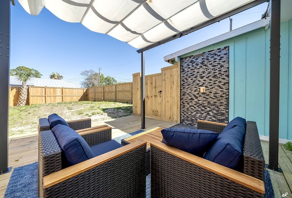 Spacious Backyard with Outdoor Shower and Plush Seating