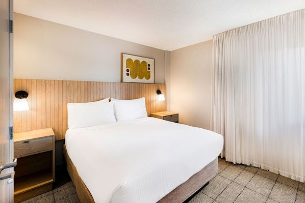 Newly renovated suite, features a private bedroom with a plush Queen bed.
