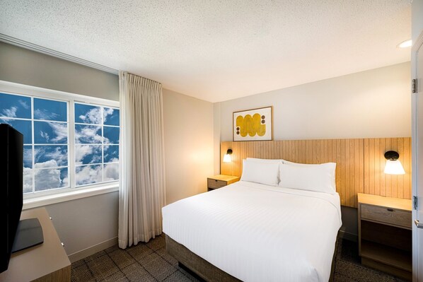 Newly renovated suite, features a private bedroom with a plush Queen bed.