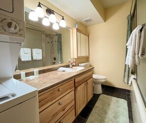 Enjoy the convenience and elegance of this well-appointed bathroom, complete with a washer and dryer. You will find everything you need for a comfortable stay, from modern fixtures to ample counter space and thoughtful amenities.