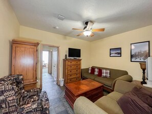 Relax in this inviting living room, designed for comfort and leisure. You will love the cozy seating, classic wooden furniture, and warm, welcoming atmosphere, ideal for unwinding after a day of exploring the great outdoors. (Large living area)