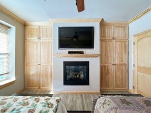 Delight in the charming blend of modern convenience and rustic warmth with a fireplace to keep you cozy on cooler nights. The mounted TV and ample storage add a touch of luxury to this inviting space. (Large bedroom with private TV, gas fireplace, and lots of storage)