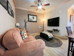 Relax in the comfort of a tastefully decorated living room, where you can enjoy your favorite shows on a large screen TV or unwind with a good book. The inviting sofa and thoughtful touches make this a perfect spot to relax. (Large main living area with pull-out sofa, dining area, and flatscreen TV)