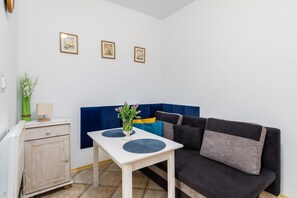 A comfortable living area with a grey sofa, a white coffee table, and decorative accents.
