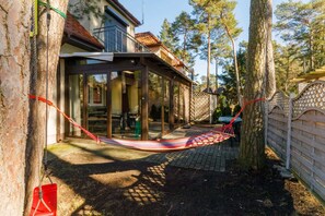 An exterior view of the property with a charming garden and outdoor seating area.

