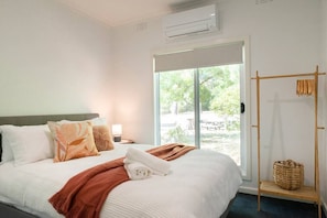 Bedroom 1: Cozy queen bed, heating/cooling options for comfort.