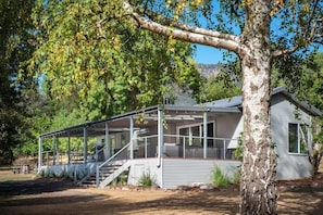 Welcome to our renovated home! Modern comfort indoors, outdoor relaxation on the deck.