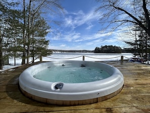 Soak in the hot tub with beautiful views of the lake.