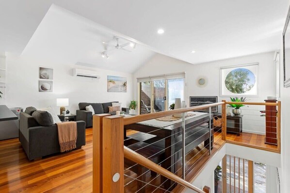 The upper-level family hub is bathed in natural light, thanks to high-pitched ceilings and large windows