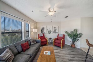 Living room offers guests ample, comfortable seating and large flat screen television.