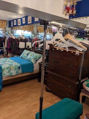 Clothes rack next to dresser