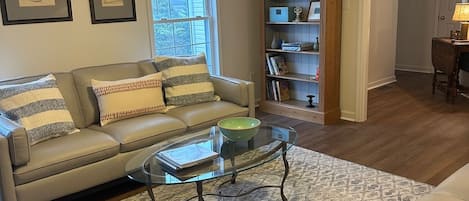 Spacious living room with 2 large leather couches. 