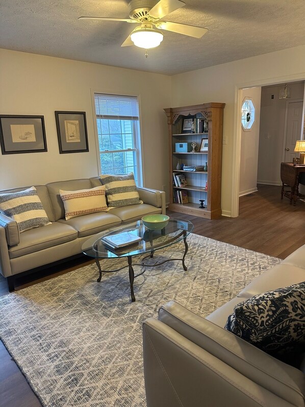 Spacious living room with 2 large leather couches. 