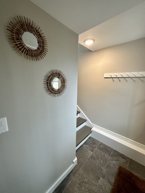 Entry foyer that leads to apartment stairs, laundry room and gym
