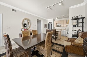 The dining table is in the center of the open living area