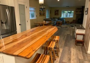 Open concept kitchen dining and living rooms. Covered porch by kitchen