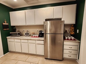 Kitchen with microwave, coffee station and added airfryer and wine station. 