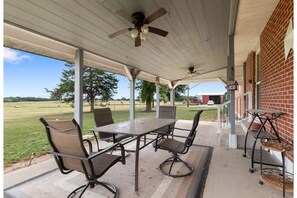 Patio with charcoal grill, ceiling fans, lights with Bluetooth, fire pit.