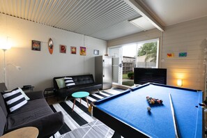 Small pool table and additional lounge/TV in garage
