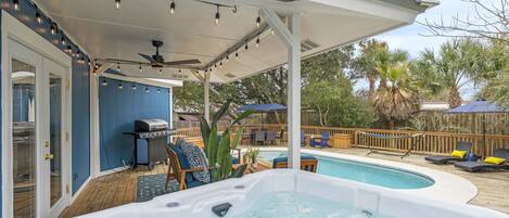 Fenced backyard with furnished patio. In-ground swimming pool and jacuzzi.