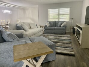 Living room has a pull-out Queen sleeper sofa.