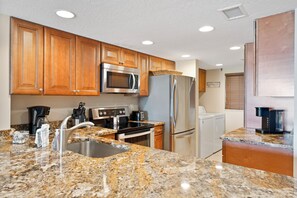Step into a fully equipped kitchen with beautiful view.